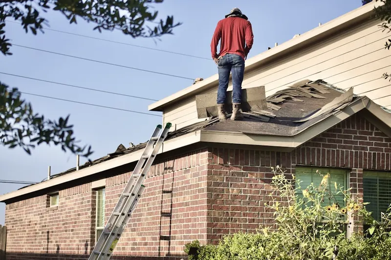 Professional roofer working on a residential roof in Avondale Estates
